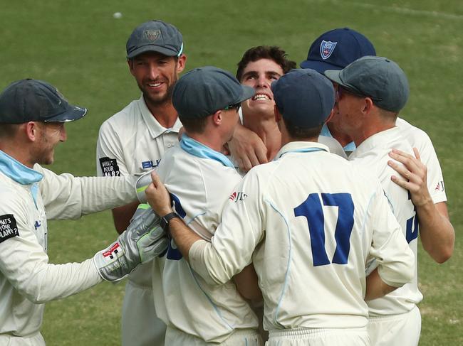 Teammates gather around man of the moment Sean Abbott. Picture: Getty Images