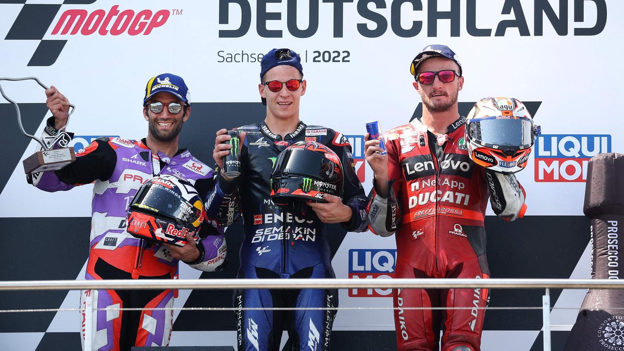 Jack Miller (right) celebrates his podium at the German MotoGP. (Photo by Ronny Hartmann / AFP)