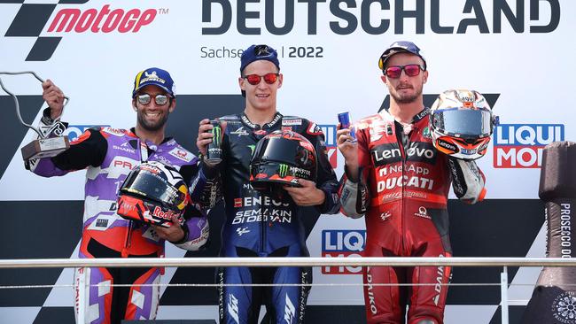 Jack Miller (right) celebrates his podium at the German MotoGP. (Photo by Ronny Hartmann / AFP)