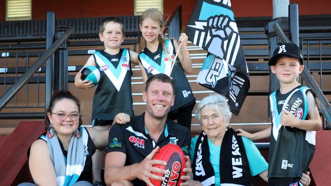 Port Adelaide midfielder Brad Ebert with 94-year-old Patricia Byrd and her great grandchildren who are all Power members — Molly King, 13, and her brother Ben, 6, Laila Sharman, 8, and her brother Eddie, 6. The Power is aiming at 65,000 members this season. Picture: Dean Martin