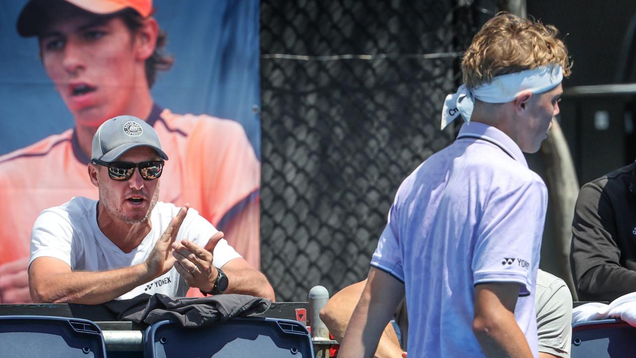 Cruz Hewitt playing on Court 10 at Melbourne Park being watched by his dad Lleyton. Picture: David Caird