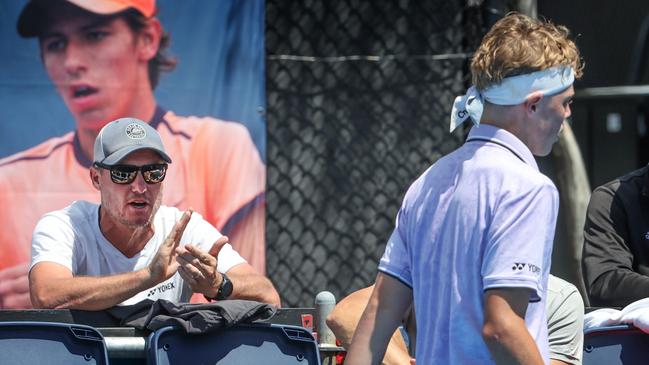 Cruz Hewitt playing on Court 10 at Melbourne Park being watched by his dad Lleyton. Picture: David Caird