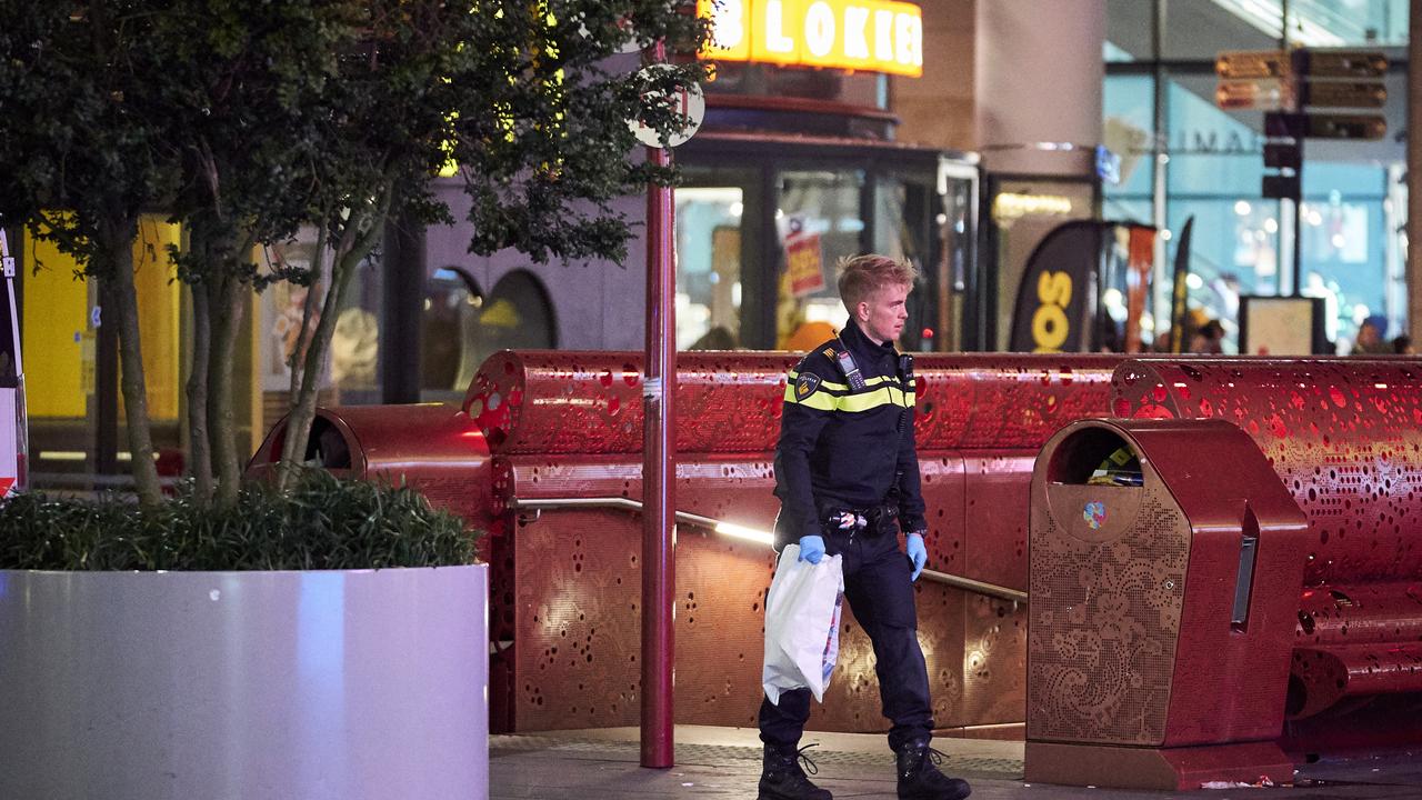 A Dutch police officer secures a bag with items from the scene of a stabbing incident. Picture: AP/Phil Nijhuis