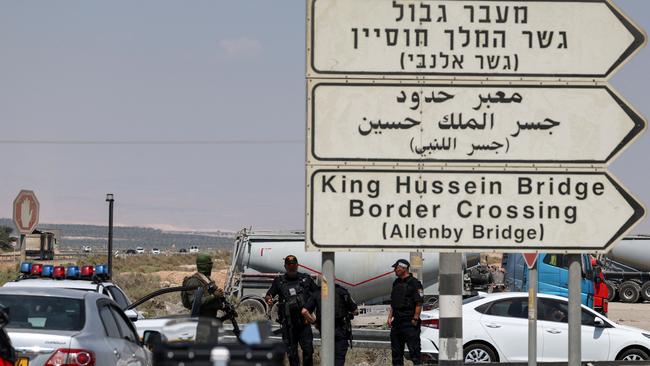 Israeli security forces gather at the scene of the attack near the Allenby Crossing. Picture: AFP.