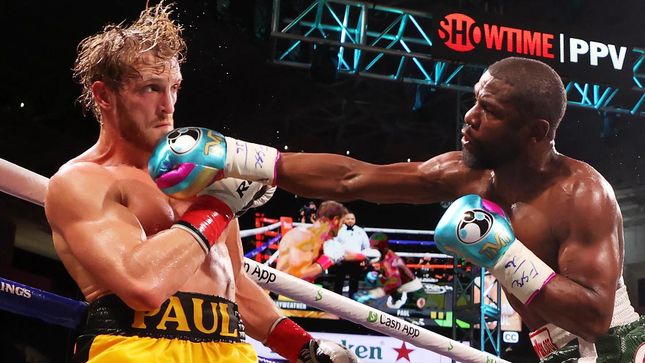 Floyd Mayweather (R) punches Logan Paul during their contracted exhibition boxing match at Hard Rock Stadium on June 06, 2021 in Miami Gardens, Florida.