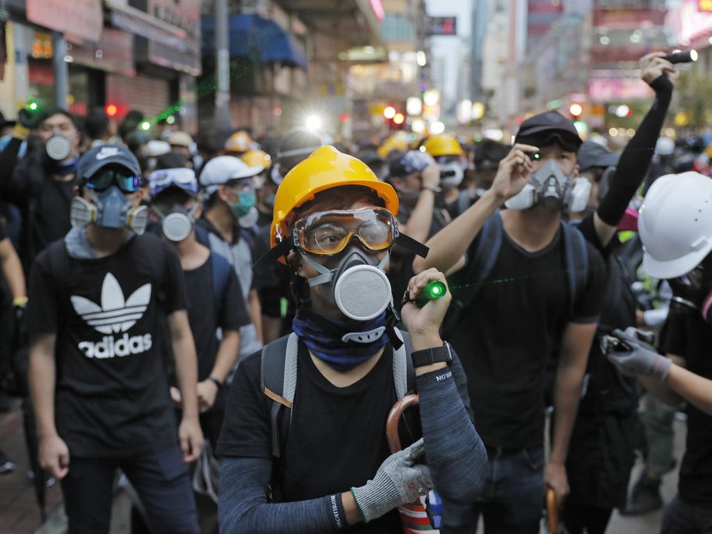 Protesters use laser pointers to beam at policemen during the anti-extradition bill protest in Hong Kong. Picture: Kin Cheung/AP