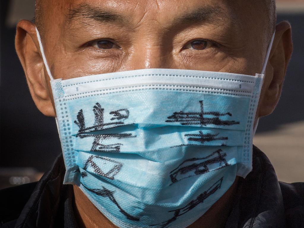 A man attends a memorial for Dr Li Wenliang, who was the whistleblower for the coronavirus that originated in Wuhan, China. Picture: Mark Ralston/AFP