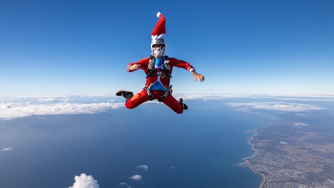 EMARGOED UNTIL 24.12.24Santa from the Great Ocean Road Skydive Australia team jumps into action over our coastline. Picture:  Logan Morris**NOT FOR PHOTOSALES**(Must mention Skydive Australia in ALL captions)