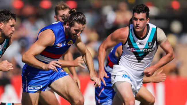 Tom Rockliff pursues Marcus Bontempelli during the Marsh Series. Picture: Matt Turner/AFL Photos via Getty Images.