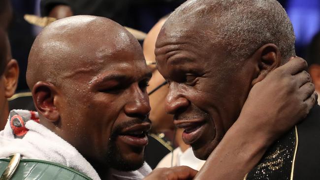 Floyd Mayweather Jr. hugs Floyd Mayweather Sr. after defeating Conor McGregor by TKO in their super welterweight boxing match on August 26, 2017 at T-Mobile Arena in Las Vegas, Nevada. (Photo by Christian Petersen/Getty Images)