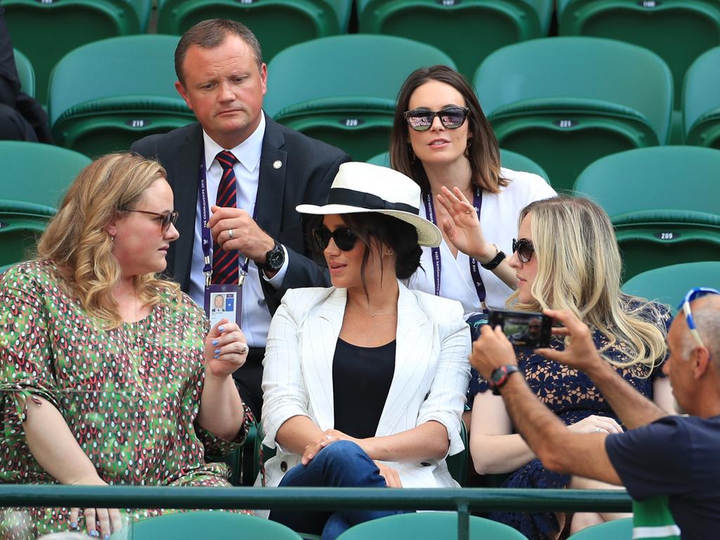 A fan takes a selfie in front of the Duchess of Sussex who was attending Wimbledon in a “private capacity”. Picture: Mike Egerton