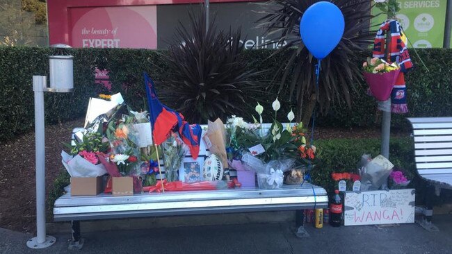 The seat where Wanga used to sit at Lake Have Shopping Centre was covered in flowers and tributes. Picture: Facebook.