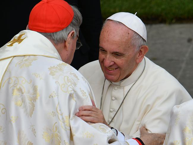 Pope Francis, right, greets cardinal George Pell of Australia after the celebration of mass. Picture: AFP