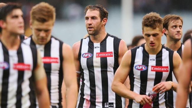 Travis Cloke and his dejected teammates walk off the MCG.