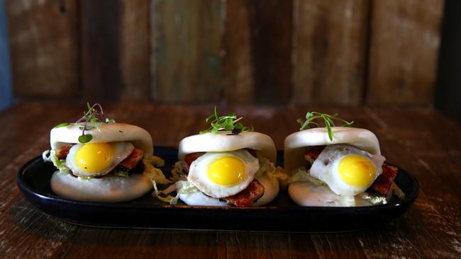 Double Barrel’s Brekkie Bao: steamed soft Chinese bao bun, thick-cut free-range bacon, quail egg and relish. Photo: David Clark