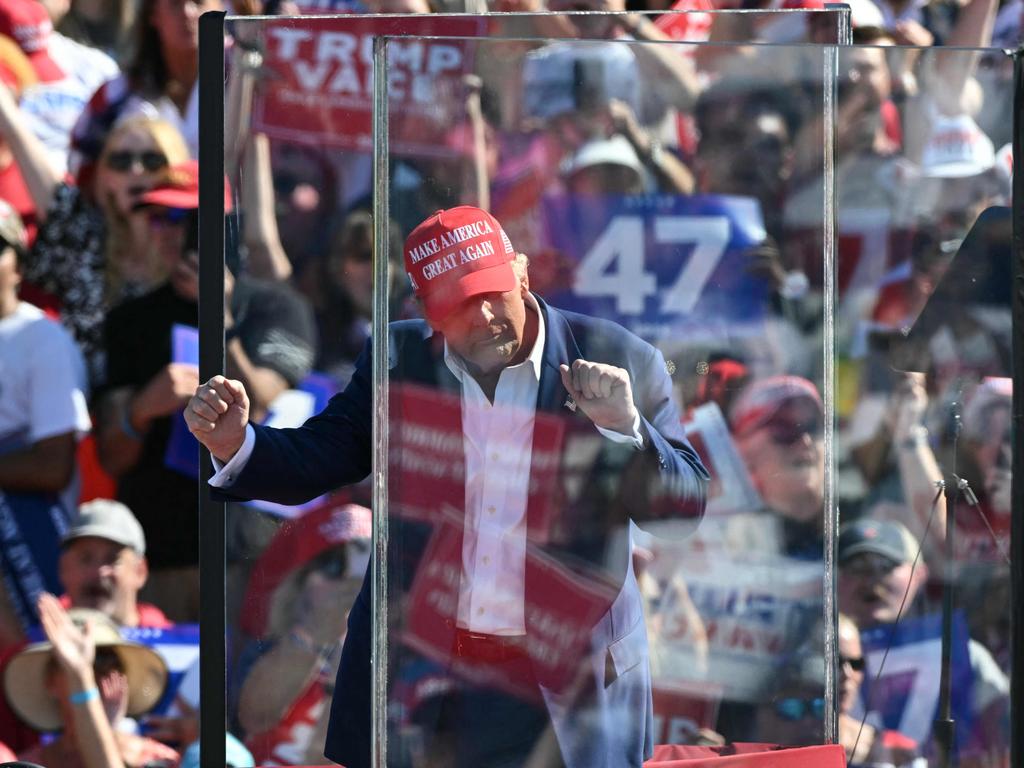 Former US President and Republican presidential candidate Donald Trump dances behind bulletproof glass as he concludes his remarks during a campaign rally at the Aero Center in Wilmington, North Carolina, on the weekend. Picture: AFP