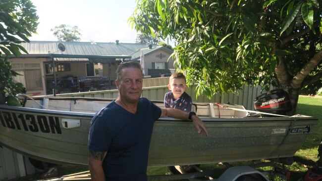 Clayton Yuille with his grandson, Kade Yuille, 5, and the boat that he bought for Jack. Pic Daniel Mills