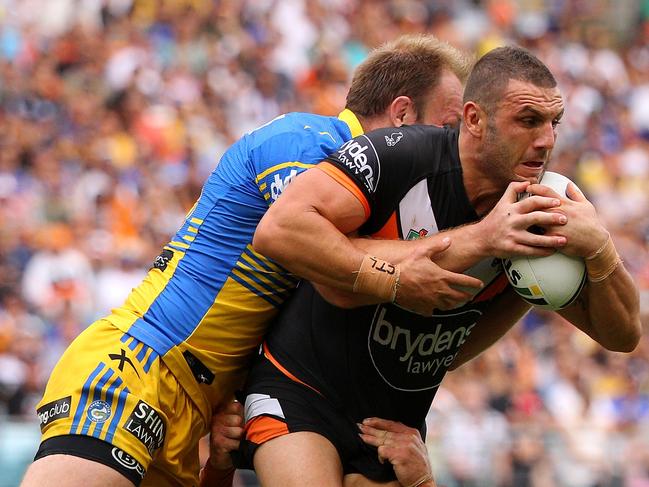 SYDNEY, NEW SOUTH WALES - MARCH 28: Robbie Farah of the Tigers is tackled during the round four NRL match between the Wests Tigers and the Parramatta Eels at ANZ Stadium on March 28, 2016 in Sydney, Australia. (Photo by Matt Blyth/Getty Images)