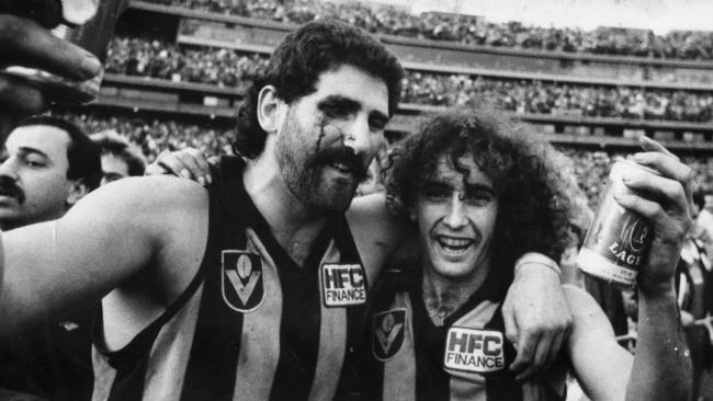 Robert DiPierdomenico and John Platten celebrating with a can of beer. after the 1986 Hawthorn versus Carton VFL Grand Final at the MCG. Picture: Stuart Hannagan