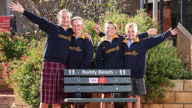 St Brigid’s Primary School students Ella, 11, Hannah, 11, Caleb, 12 and Samuel, 11, celebrate their newly donated Buddy Bench from Coles. Picture: Russell Millard.