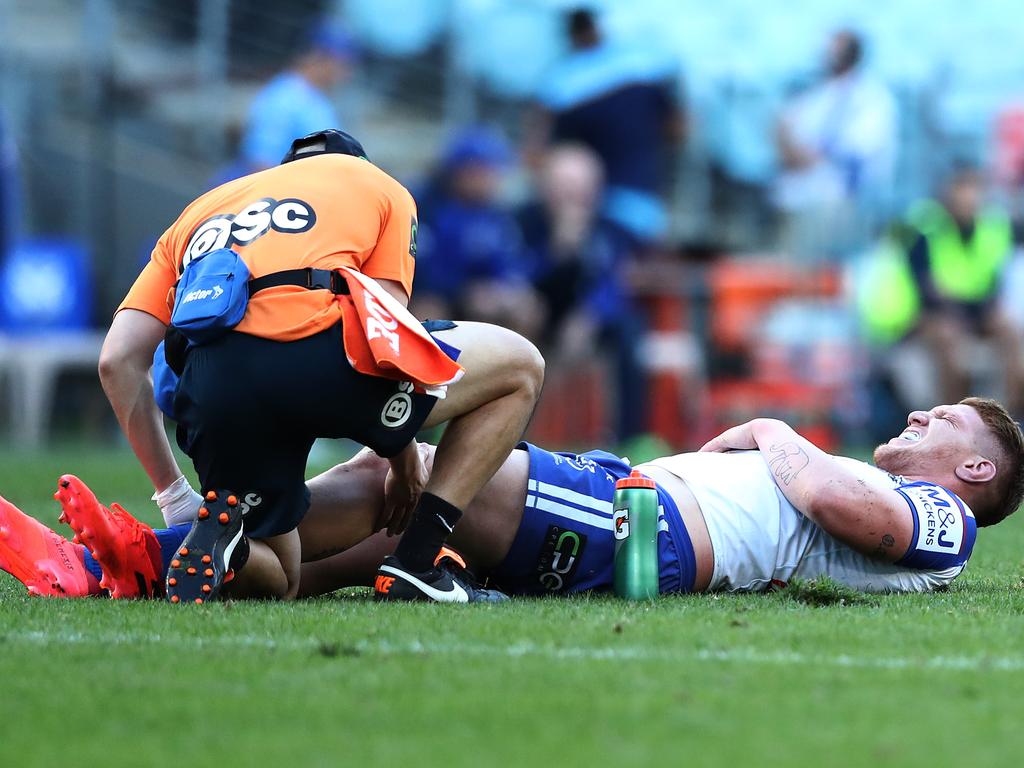 Dylan Napa is attended to by a trainer after his knee injury.