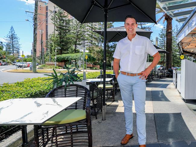 Broadbeach council candidate Darren Taylor is currently pounding the pavement, listening to locals, tourism, community groups and business uncovering truths especially on pavement dining. HeÕs pictured talking to restaurant employee Joanna Poenset. Pic Tim Marsden