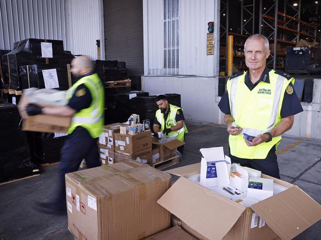 ABF Superintendent Graeme Campbell (front) with other ABF officers and vaping products suspected of having illegal nicotine contents. Picture: Sam Ruttyn