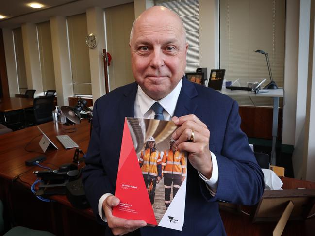 Victorian Treasurer Tim Pallas with the 2023-2024 Victorian Budget report. Picture: David Caird