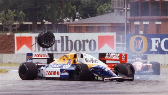 Williams driver Nigel Mansell and McLaren’s Ayrton Senna collide, sending one of Senna's tyres airborne during the 1992 race. Picture: Greg Adams)