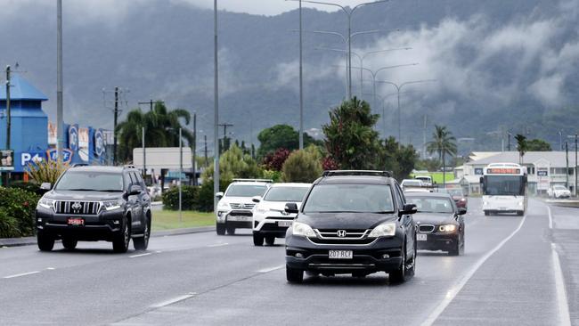 Cars and buses make their way along a wet and slippery Mulgrave Road. Picture: Brendan Radke