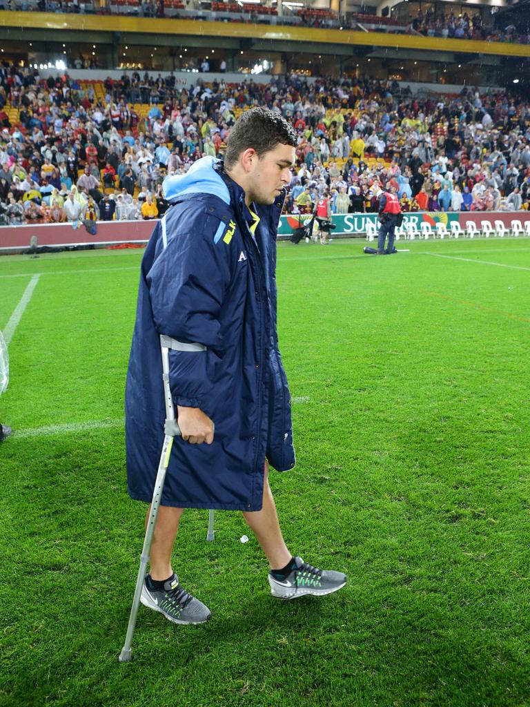 An injured Taylor limps off the field. Picture: Darren England