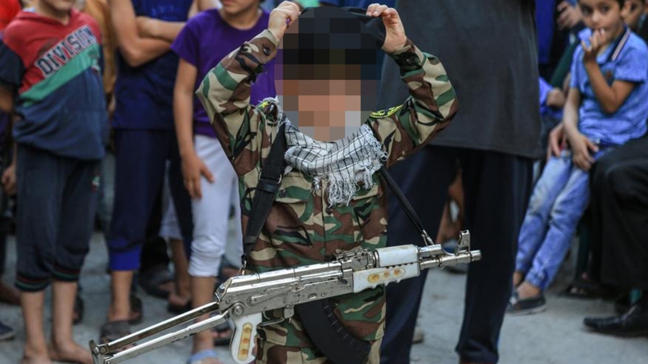 A young boy, believed to be Fayez Elhasani’s grandson, attended the memorial for his deceased father Remah wearing PIJ military clothing.