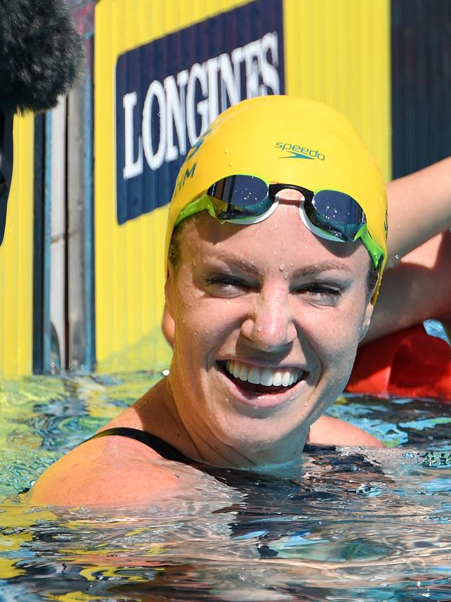 Emily Seebohm smiles after winning her 50m backstroke heat. Photo: AAP