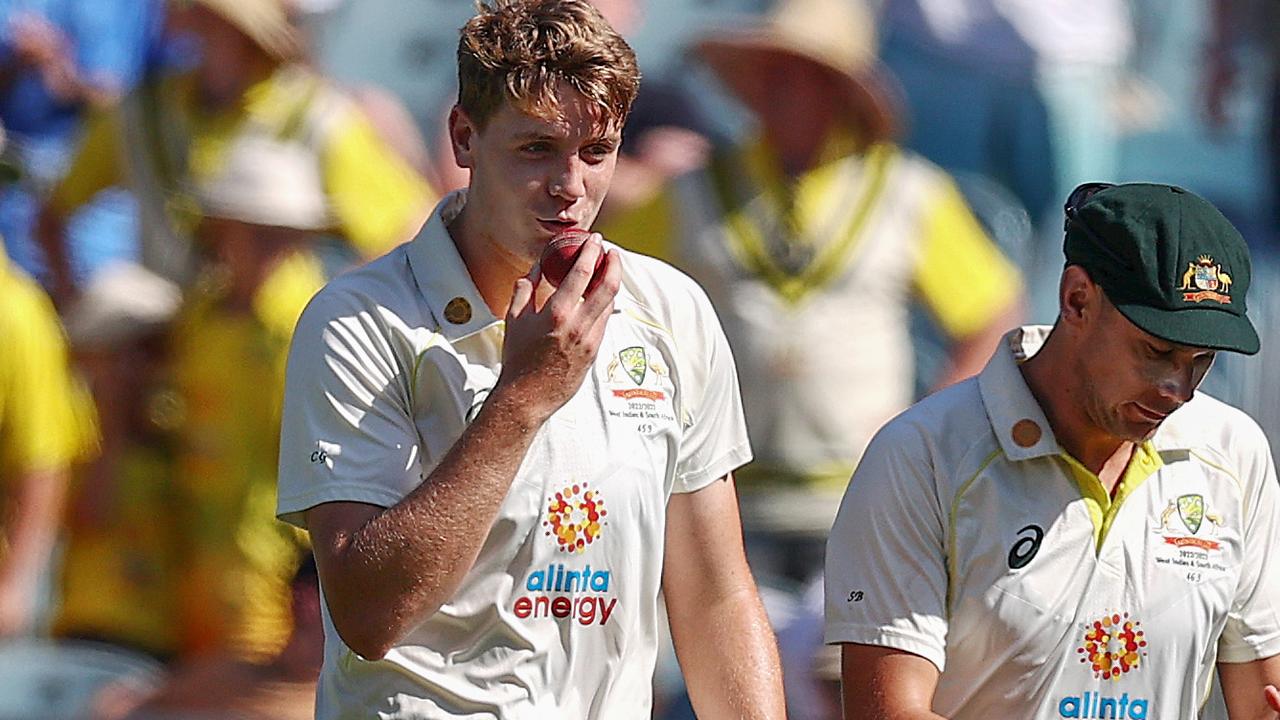 Cameron Green kisses the ball after taking his 5th wicket and wrapping up the South African innings . Picture by Michael Klein