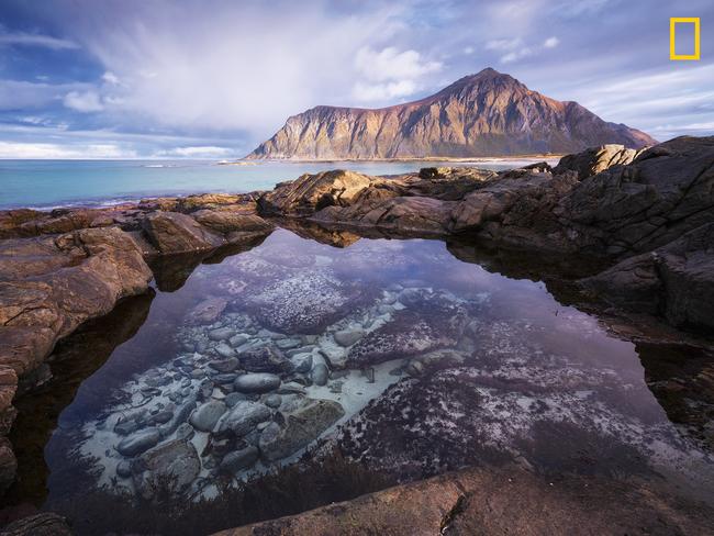 Photo by Felix Inden / National Geographic Nature Photographer of the Year contest enchanted A tidal pool at Lofoten islands in northern Norway acts as natural eye catcher. with the high tides around full moon, white sand gets washed into the pool and then the magic unfolds.