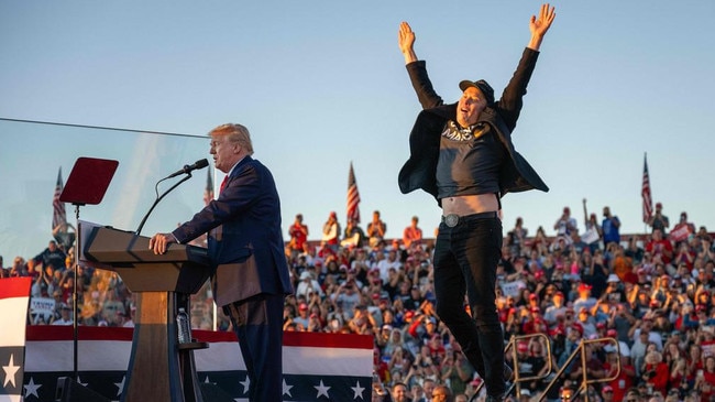 Elon Musk jumps on stage as he joins Trump during a campaign rally last month. Picture: Jim Watson / AFP