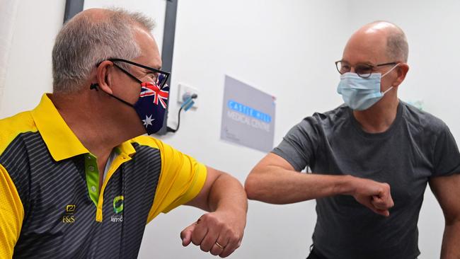 Then PM Scott Morrison bumps elbows with Chief Medical Officer Paul Kelly in February 2021. Picture: AFP