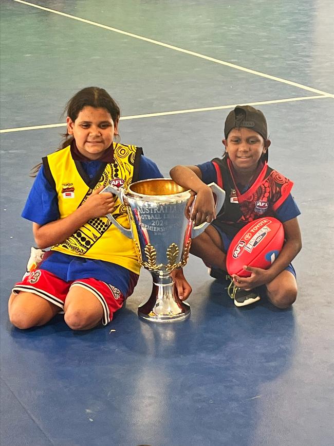 Sadadeen Primary School students with the AFL premiership cup in Alice Springs, September, 2024.