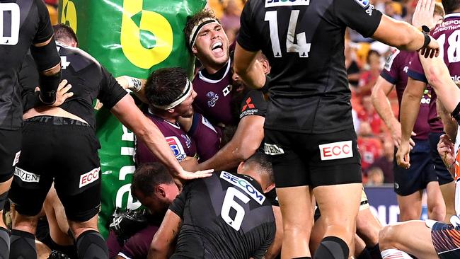 Angus Scott-Young of the Reds celebrates a try by team mate Brandon Paenga-Amosa on Friday night. Picture: Getty Images 