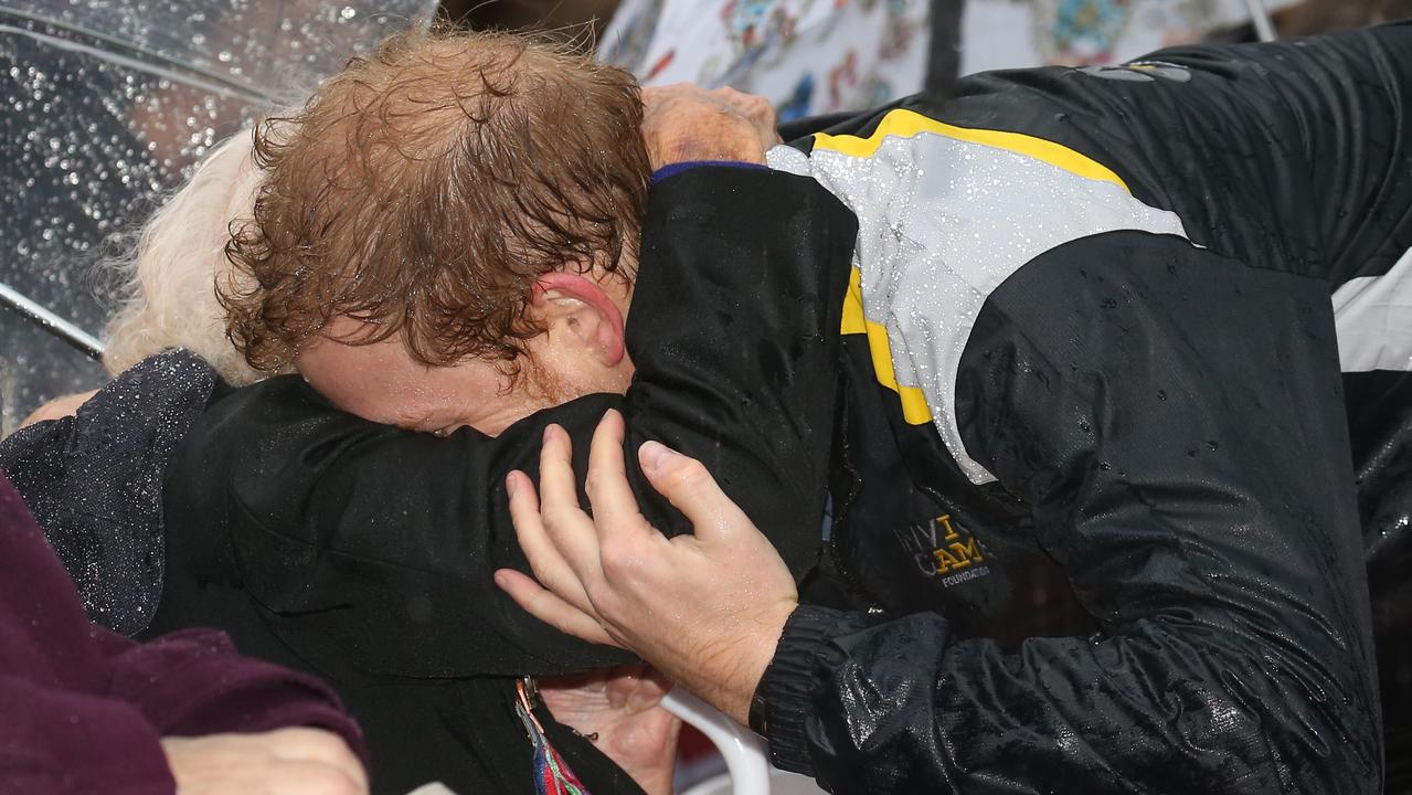 Braving the cold and the rain, Mrs Dunne had camped out at Admiralty House to see the Prince in 2017, but missed her chance so she moved to wait with the crowds in Circular Quay where she received this adorable embrace from the Prince. Picture: Toby Zerna.