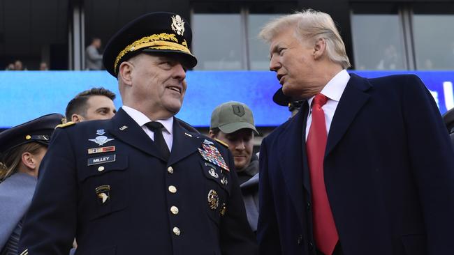 President Donald Trump, right, talks with Army Chief of Staff General Mark Milley during a college football game in Philadelphia on Saturday. Picture: AP