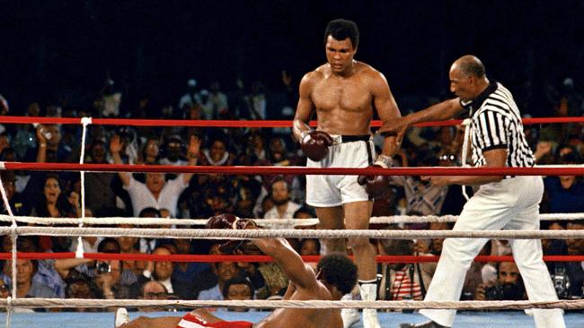 Referee Zack Clayton steps in after challenger Muhammad Ali looks on after knocking down George Foreman in the eighth round of their championship bout in Kinshasa, Zaire in 1974.