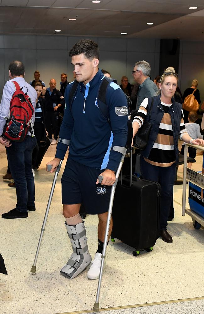 Nathan Cleary arrives at Sydney Domestic Airport in Sydney after injuring his ankle in Origin 2.