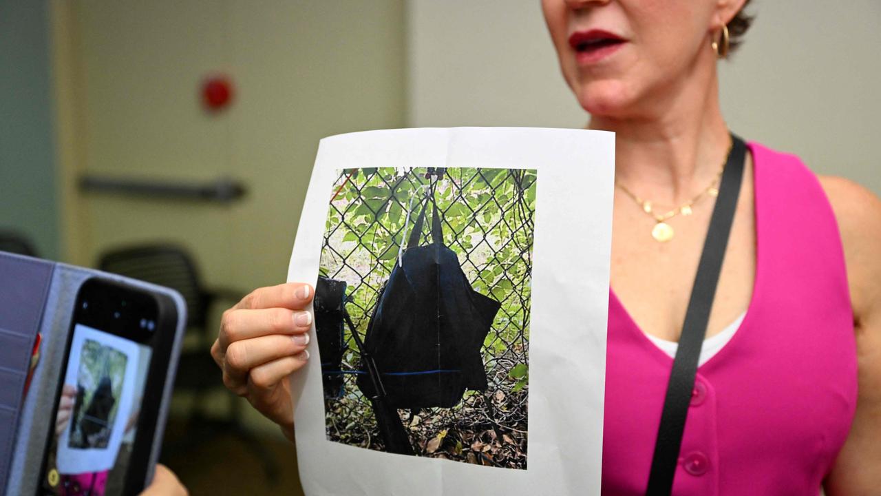 Press Information Officer Teri Barbera shows pictures of evidence found at the fence of US presidential candidate Donald Trump's golf course, at a press conference in West Palm Beach, Florida, on September 15, following the incident. Picture: Chandan Khanna/AFP