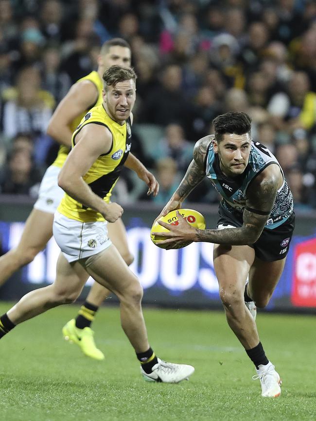 Port Adelaide’s Chad Wingard looks to clear the football against Richmond. Picture Sarah Reed