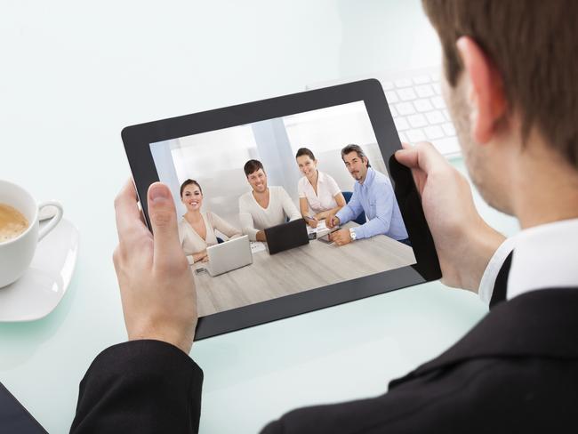 Close-up Of Businessman Looking At Video Conference On Digital Tablet Picture: iStock