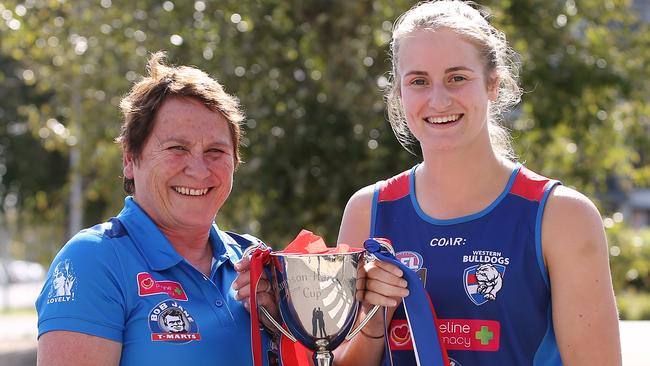 Lisa Hardeman and Western Bulldogs player Ellyse Gamble with the Hampson-Hardeman Cup, which the Bulldogs and Demons will play for on Saturday night. Picture: Wayne Ludbey