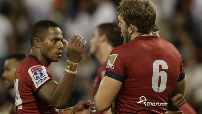 Filipo Daugunu and Angus Scott-Young celebrate the Reds’ win.