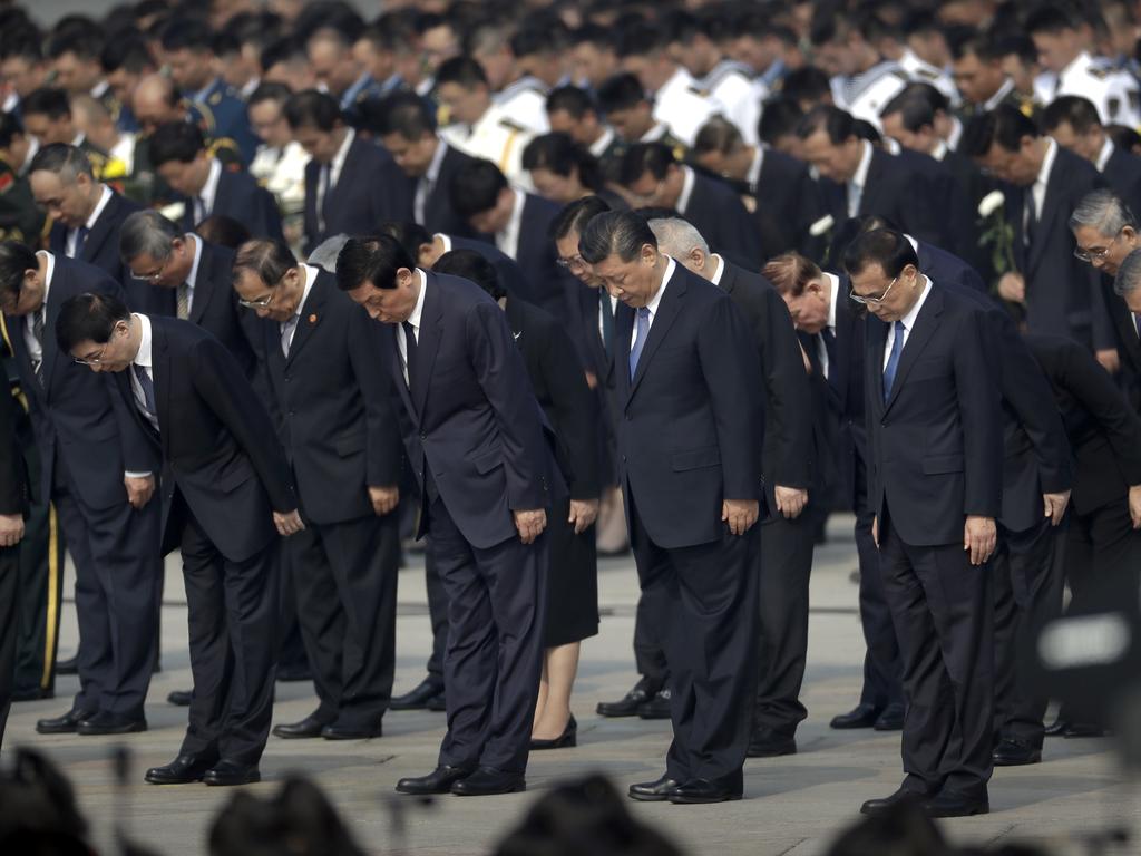 Chinese President Xi Jinping and other officials bow during a ceremony to mark Martyr's Day at Tiananmen Square. Picture: AP