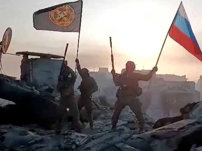 This video grab posted on Telegram shows members of Wagner group waving a Russian national flag and Wagner Group's flag in Bakhmut. Picture: AFP